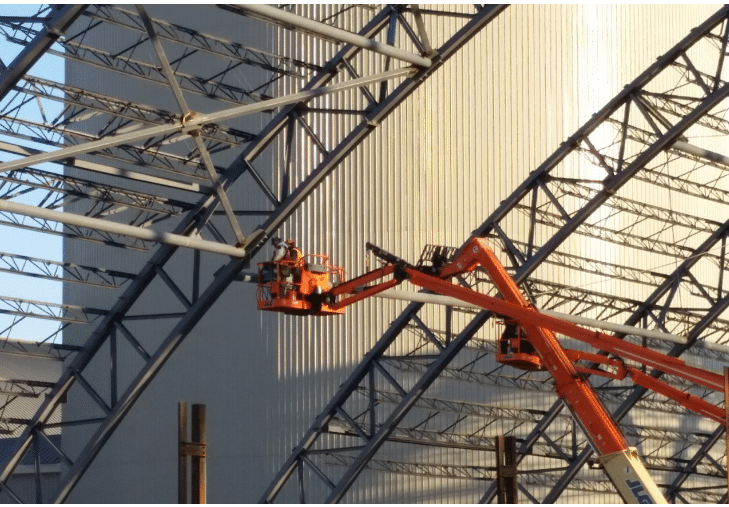 Construction workers on a crane.