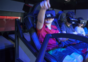 Three children wearing virtual reality headsets.